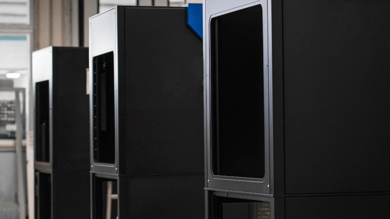 Industrial laser marking systems with enclosed safety cabinets in a production environment